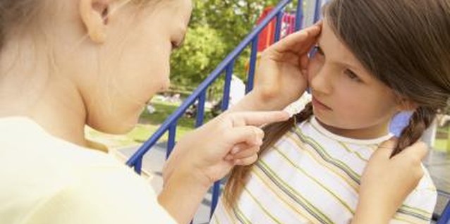 BananaStock/BananaStock/Getty Images Make sure dominating behavior at home doesn't become a problem on the playground.