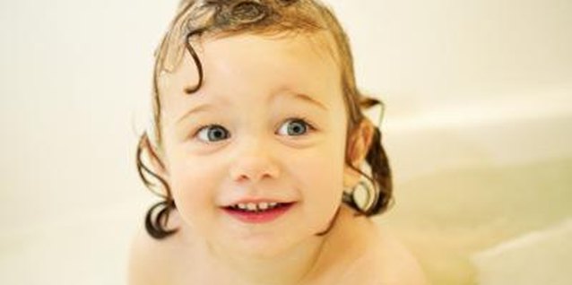 Thinkstock Images/Comstock/Getty Images Teach your toddler to blow bubbles in the tub first.
