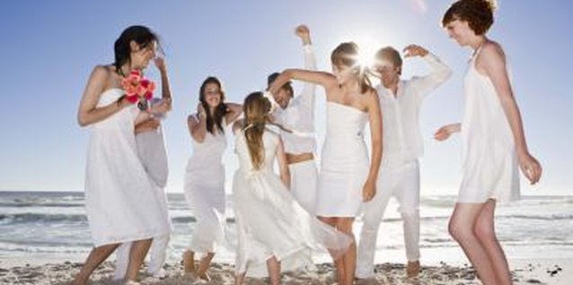 Jupiterimages/Polka Dot/Getty Images Decorate flip-flops to wear at a destination beach wedding.