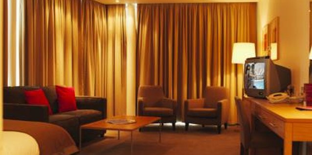 George Doyle/Stockbyte/Getty Images Mount pleated curtains for consistent fullness across a wall.