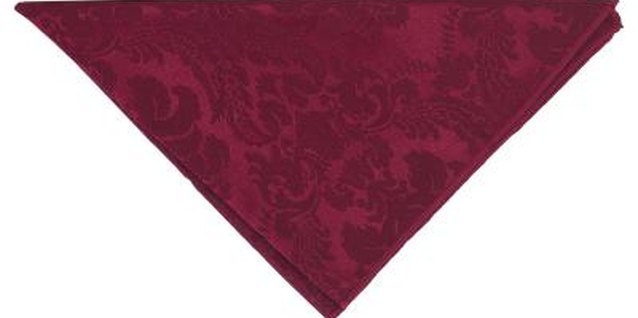Hemera Technologies/PhotoObjects.net/Getty Images A red or green cloth napkin can be turned into a decorative Christmas tree.