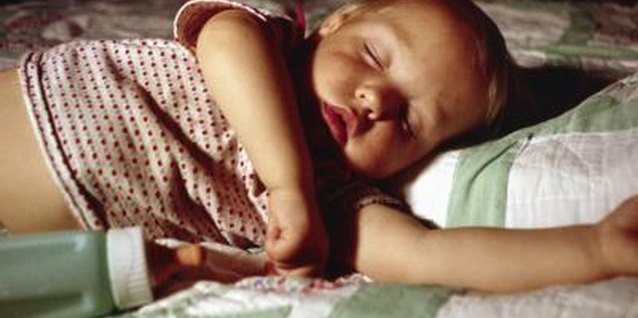 Ablestock.com/AbleStock.com/Getty Images Sleeping with a bottle promotes tooth decay.