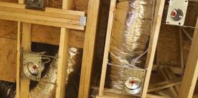 Thinkstock/Comstock/Getty Images Air ducts and vents are positioned in the studs prior to drywall installation.