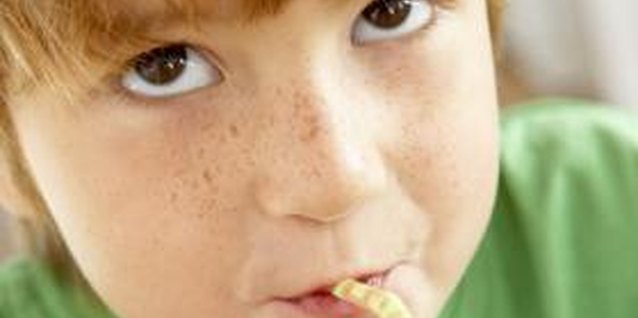 BananaStock/BananaStock/Getty Images Sweetened drinks like soda can contribute to childhood tooth decay.