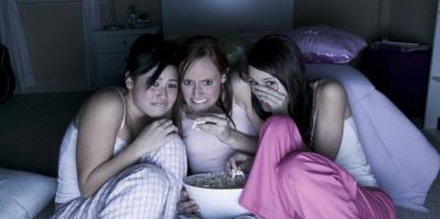 Photodisc/Photodisc/Getty Images Host a fright night for your brave, young teens.