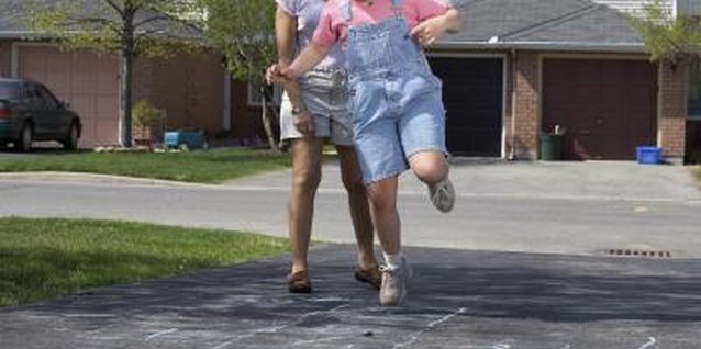 Jupiterimages/Photos.com/Getty Images Adding sight words to hopscotch stretches your child's body and her mind.