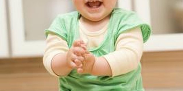 BananaStock/BananaStock/Getty Images Praising your toddler can help her develop.