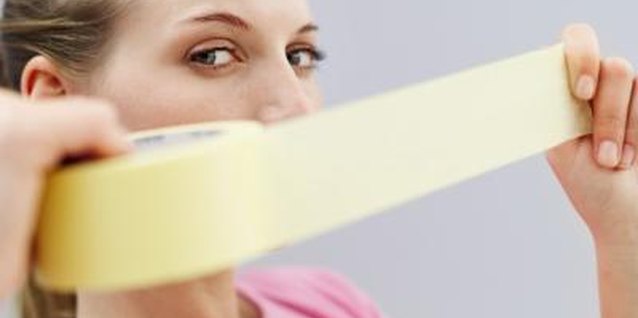 Stockbyte/Stockbyte/Getty Images Painter's tape creates straight-edged designs for painted wall patterns.