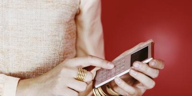 Digital Vision./Digital Vision/Getty Images Subtle gold accessories complete the outfit.