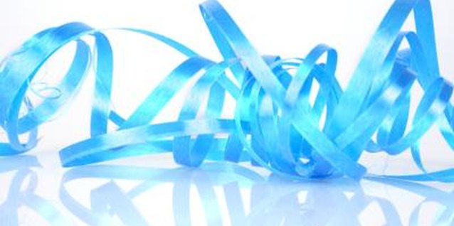Visage/Stockbyte/Getty Images Add a party feel to your lollipop-cone centerpiece by tucking in strands of curly ribbon tied to toothpicks.