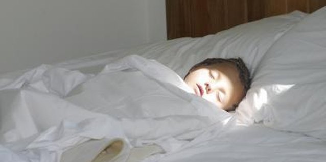 Comstock/Comstock/Getty Images Let a small amount of sunlight in the room while he's waking.