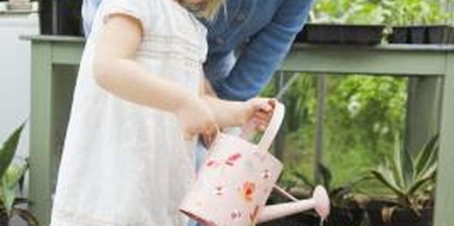 Jupiterimages/BananaStock/Getty Images Offer your little one child-sized gardening tools to make it easier to care for plants.