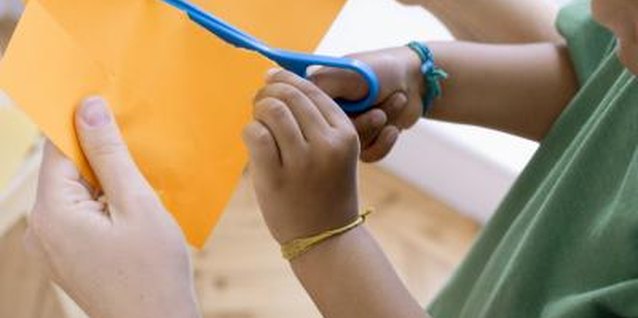 Polka Dot/Polka Dot/Getty Images Let children cut paper shapes for a collage.