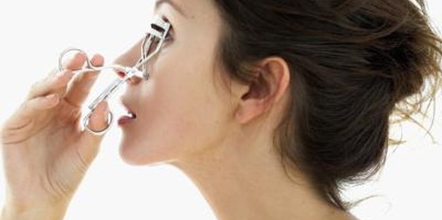 Stockbyte/Stockbyte/Getty Images Curling your lashes and applying several coats of mascara can help make your eyes look bigger.