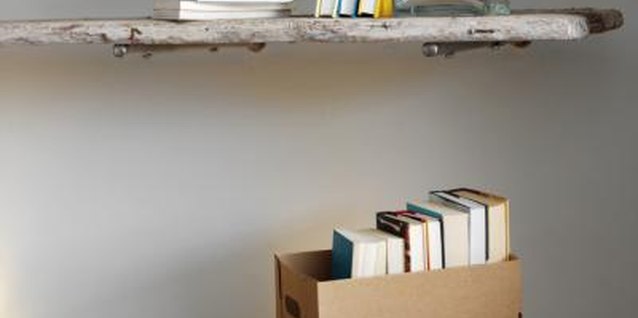 Stockbyte/Stockbyte/Getty Images Shelf brackets and scrap wood create inexpensive shelves.