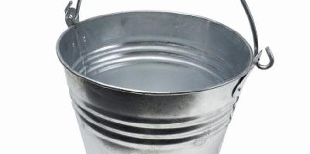 Stockbyte/Stockbyte/Getty Images You'll need a bucket to catch the old oil.
