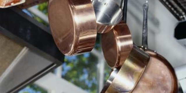 Ryan McVay/Photodisc/Getty Images An old iron gate can be used to create a stylish pot rack for your kitchen.