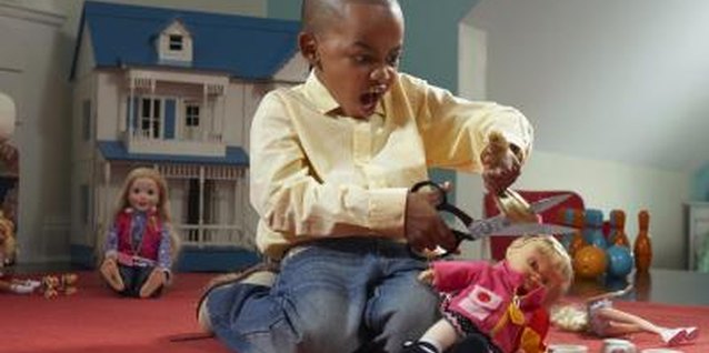 Darrin Klimek/Digital Vision/Getty Images Your son can learn to play with dolls.