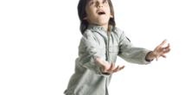 Photodisc/Photodisc/Getty Images Catching activities and games are the perfect way to enhance gross motor skills in preschoolers.