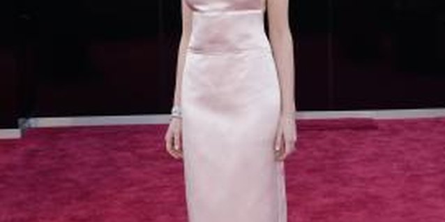Jason Merritt/Getty Images Entertainment/Getty Images Actress Anne Hathaway is stunning in a pale-pink sheath and statement necklace.