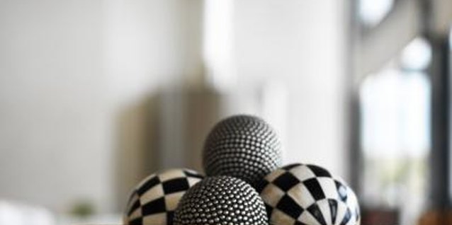 George Doyle/Stockbyte/Getty Images A simple white bowl is elevated in its elegance by a selection of ceramic orbs.