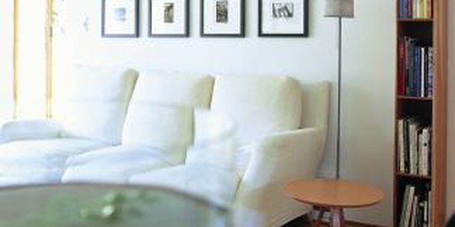 Digital Vision./Digital Vision/Getty Images A simple grouping with matching frames decorates the space above the sofa perfectly.