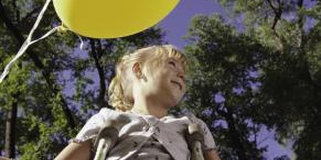 Photodisc/Photodisc/Getty Images Prevent aggravating your child's injury by teaching her how to walk on crutches.