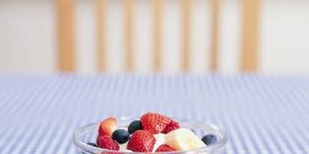 Digital Vision./Digital Vision/Getty Images Easy-care fabrics with a solid color or small pattern dresses up your table.