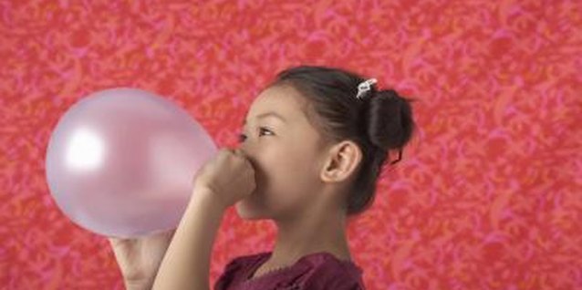 Sean Justice/Stockbyte/Getty Images Show your child how her breath can turn a balloon into a rocket.