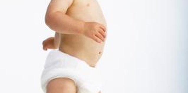 George Doyle/Stockbyte/Getty Images Bare feet are best for babies learning to walk.