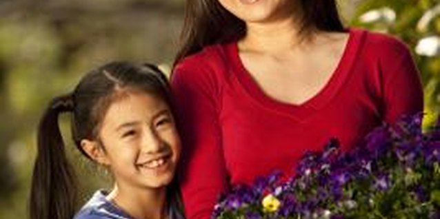 Comstock Images/Stockbyte/Getty Images Teach your children about gardening with the help of raised flower beds.