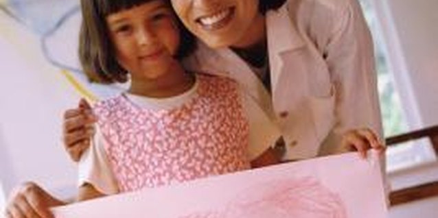 Stockbyte/Stockbyte/Getty Images She creates a big card so you will know how much she loves you.