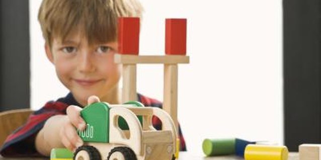 Jupiterimages/Polka Dot/Getty Images Children with autism might play with toys in a repetitive manner.