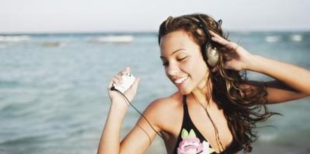 Jupiterimages/Brand X Pictures/Getty Images Monitoring your teen's music may help you stay close to her.