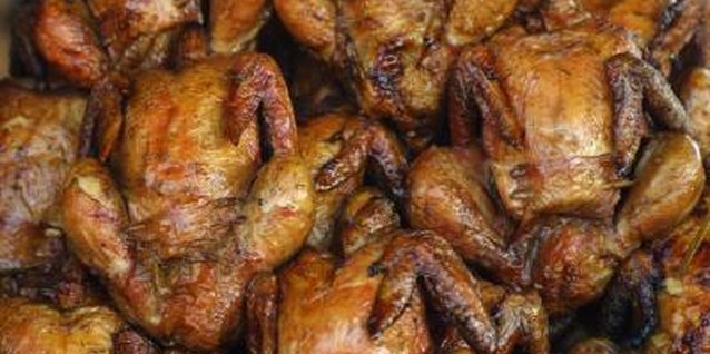 Hemera Technologies/AbleStock.com/Getty Images More chickens fit on the grill when you cook them upright.