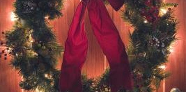 Comstock Images/Stockbyte/Getty Images Hang a prelit wreath on a door that only requires the flip of a switch on a battery pack to turn on and enjoy.