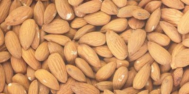 Hemera Technologies/Photos.com/Getty Images Blanch and peel almonds to prepare them for grinding.