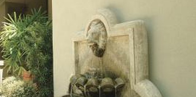 Comstock/Comstock/Getty Images A wall fountain can provide an impressive point of focus.