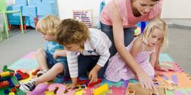 Jupiterimages/Goodshoot/Getty Images Preschoolers need guidance when learning to work together.