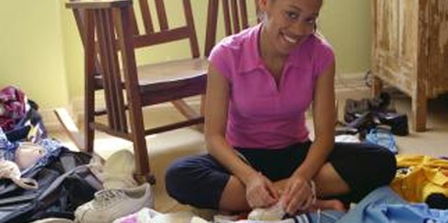 Creatas/Creatas/Getty Images Help your teen tend to her cluttered room through the use of organizational tools.