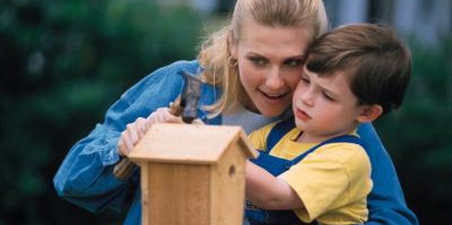 Comstock/Comstock/Getty Images Decorate a bird house together and watch the birds flock to the new feeder.