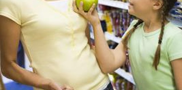 BananaStock/BananaStock/Getty Images Older children can help find items on the list while you grocery shop.