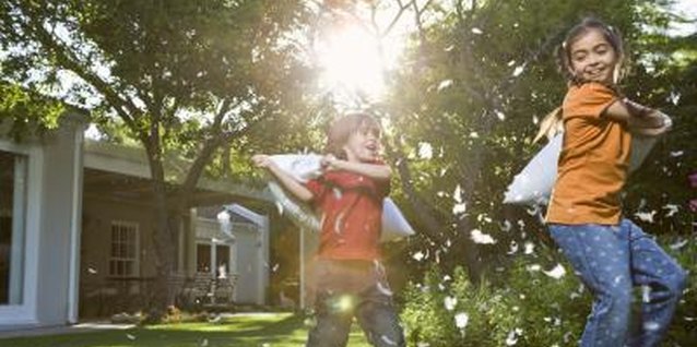 Jupiterimages/BananaStock/Getty Images Fertilizer can create a greener lawn.