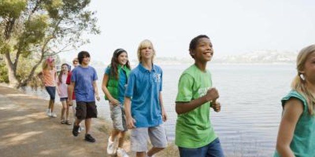 Jupiterimages/Creatas/Getty Images Overnight camps for teenagers with autism include engaging activities like crafts, horseback riding, swimming and cooking.