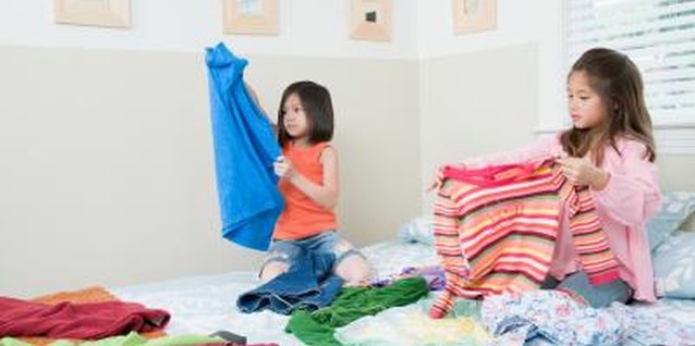 Jupiterimages/Photos.com/Getty Images Your child can help sort and fold laundry.