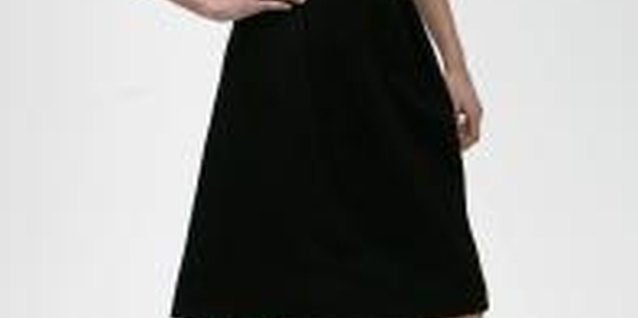 Chris Jackson/Getty Images Entertainment/Getty Images A knee-length high-waist black skirt with a button-down creates a sophisticated style.
