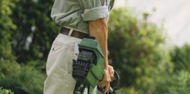 Jupiterimages/liquidlibrary/Getty Images String trimmers give the lawn a finished look.