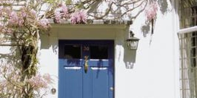 Medioimages/Photodisc/Photodisc/Getty Images With a neutral-color exterior, you can make a statement by using bright blue or green for your front door.