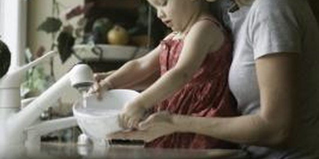 Photodisc/Photodisc/Getty Images Allowing your child to help with basic tasks makes her feel important.