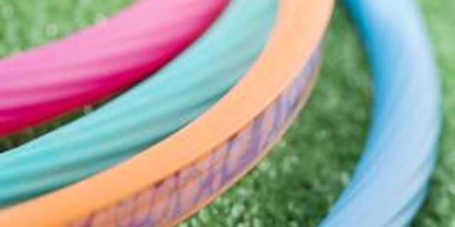 Jupiterimages/liquidlibrary/Getty Images Challenge teens to hula hoop with two or three hoops at once.